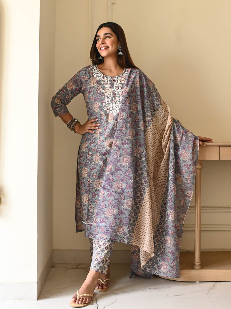Smiling woman in a grey cotton suit set with dupatta.